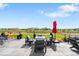 Outdoor patio space with a fire pit, comfortable seating, lush landscaping, and neighborhood views at 15640 Spruce St, Thornton, CO 80602