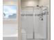 Bright bathroom featuring a soaking tub and a tiled shower with a glass door and a built-in bench at 15640 Spruce St, Thornton, CO 80602