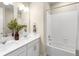Bathroom featuring a double vanity with modern fixtures and a shower-tub combination with white tile surround at 15640 Spruce St, Thornton, CO 80602