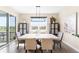 Bright dining room with large windows, modern chandelier, and stylish dining set at 15640 Spruce St, Thornton, CO 80602