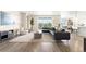 Spacious living room featuring large windows, a modern sectional sofa, and stylish decor at 15640 Spruce St, Thornton, CO 80602