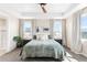 Spacious main bedroom featuring a tray ceiling, dual windows, and a cozy, inviting atmosphere at 15640 Spruce St, Thornton, CO 80602