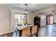 Dining area with a dark wood table, comfortable chairs, and sliding glass doors to the backyard at 7244 W Portland Ave, Littleton, CO 80128