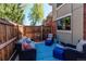 Private patio with cozy seating area and wooden fence for outdoor relaxation at 7244 W Portland Ave, Littleton, CO 80128