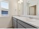 Bathroom with double sinks and gray cabinets at 27480 E Cedar Pl, Aurora, CO 80018