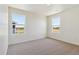 Well-lit bedroom with two windows and carpet flooring at 27480 E Cedar Pl, Aurora, CO 80018