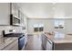 Modern kitchen with gray cabinets, granite countertops and island at 27480 E Cedar Pl, Aurora, CO 80018