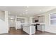 Modern kitchen with gray cabinets, granite countertops, and island at 27480 E Cedar Pl, Aurora, CO 80018