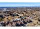 Sweeping aerial shot captures a neighborhood nestled among trees, with city and mountain views at 7352 E 7Th Ave # 7, Denver, CO 80230