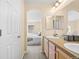 Bathroom with dual sinks leading to the bedroom with a comfortable bed at 7352 E 7Th Ave # 7, Denver, CO 80230