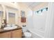 Well-maintained bathroom featuring a shower-tub combo, vanity with sink, and a window for natural light at 7352 E 7Th Ave # 7, Denver, CO 80230