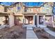 Attractive townhome exteriors with brick, covered porches, and sidewalks at 7352 E 7Th Ave # 7, Denver, CO 80230