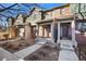 Charming townhouse exterior with brick accents, covered entryway, and well-maintained landscaping at 7352 E 7Th Ave # 7, Denver, CO 80230