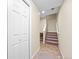 Inviting hallway with tile flooring, leading to carpeted stairs and a closet with paneled doors at 7352 E 7Th Ave # 7, Denver, CO 80230