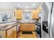 Modern kitchen with stainless steel appliances, wood cabinets, and ample counter space at 7352 E 7Th Ave # 7, Denver, CO 80230
