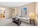 Cozy living room featuring a comfortable sofa, stylish coffee table, and ample natural light from the window at 7352 E 7Th Ave # 7, Denver, CO 80230