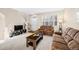 Bright living room featuring neutral walls, plush carpeting, and a cozy seating arrangement at 7352 E 7Th Ave # 7, Denver, CO 80230