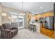 Cozy living space featuring a carpeted floor, chair, and access to the kitchen at 7352 E 7Th Ave # 7, Denver, CO 80230