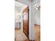 Bathroom view with wood door and pedestal sink with views to bedroom with hardwood floors at 3419 Stuart St, Denver, CO 80212