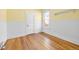 Bright bedroom with wood floors, wainscotting, and fresh yellow paint at 3419 Stuart St, Denver, CO 80212