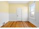 Bright bedroom with wood floors, wainscotting, and fresh yellow paint at 3419 Stuart St, Denver, CO 80212