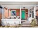 Inviting front porch with seating, framed by white columns and a bright green door at 3419 Stuart St, Denver, CO 80212