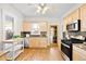 Traditional kitchen with wooden cabinets, stainless steel appliances, granite countertops, and hardwood floors at 3419 Stuart St, Denver, CO 80212