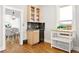 Kitchenette with wood cabinets, granite countertops, and a dining room view with hardwood floors at 3419 Stuart St, Denver, CO 80212