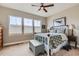 Cozy bedroom with three bright windows, a white-trimmed bed, and stylish decor at 12650 W Big Horn Cir, Broomfield, CO 80021