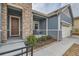 Inviting covered porch with stone pillars, outdoor seating, and a well-maintained entrance at 12650 W Big Horn Cir, Broomfield, CO 80021