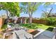 Landscaped backyard featuring a patio seating area, mature trees, and a well-maintained lawn at 3332 N Vine St, Denver, CO 80205