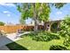 Serene backyard oasis with lush grass, mature trees, and comfortable seating on a patio at 3332 N Vine St, Denver, CO 80205