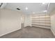 Finished basement space featuring a carpeted floor and wall shelves at 3332 N Vine St, Denver, CO 80205