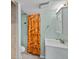 Cozy bathroom featuring a vanity, toilet, and shower with a vibrant, patterned curtain at 3332 N Vine St, Denver, CO 80205