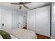 Bright bedroom features hardwood floors, ceiling fan, and built-in white wardrobe closet at 3332 N Vine St, Denver, CO 80205