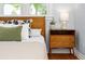 Well-lit bedroom with wood headboard, side table and large window at 3332 N Vine St, Denver, CO 80205