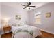Bedroom with hardwood floors, a ceiling fan, and a large window with brick views at 3332 N Vine St, Denver, CO 80205