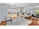 Light-filled dining area with wood floors open to the living room at 3332 N Vine St, Denver, CO 80205