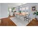 Bright dining room featuring a wooden table, modern chairs, and views to kitchen at 3332 N Vine St, Denver, CO 80205