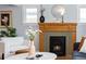 Close-up of a classic fireplace with detailed wood mantel and tiled surround in a cozy living room at 3332 N Vine St, Denver, CO 80205