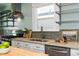 Modern kitchen featuring stainless steel appliances, stone countertops, and ample storage at 3332 N Vine St, Denver, CO 80205
