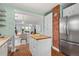 Open-concept kitchen featuring an island, modern appliances, and view to living spaces at 3332 N Vine St, Denver, CO 80205