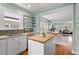 Stylish kitchen with an island and open to the living and dining areas at 3332 N Vine St, Denver, CO 80205