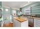 Well-lit kitchen with butcher block island, stainless steel appliances, and modern fixtures at 3332 N Vine St, Denver, CO 80205