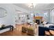 Bright living room with hardwood floors, fireplace, and an open layout to the dining area at 3332 N Vine St, Denver, CO 80205