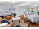 Bright and open living room with hardwood floors flowing into the dining area for seamless entertaining at 3332 N Vine St, Denver, CO 80205