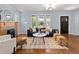 Open living room with a fireplace, hardwood floors, and stylish furniture for a modern feel at 3332 N Vine St, Denver, CO 80205