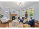 Sunlit living room with hardwood floors, fireplace, and large windows providing street view at 3332 N Vine St, Denver, CO 80205