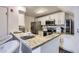 Modern kitchen with stainless steel appliances, white cabinets, and granite countertops at 9510 E Florida Ave # 3055, Denver, CO 80247