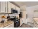 Bright kitchen featuring stainless steel appliances, granite counters, and white subway tile backsplash at 9510 E Florida Ave # 3055, Denver, CO 80247
